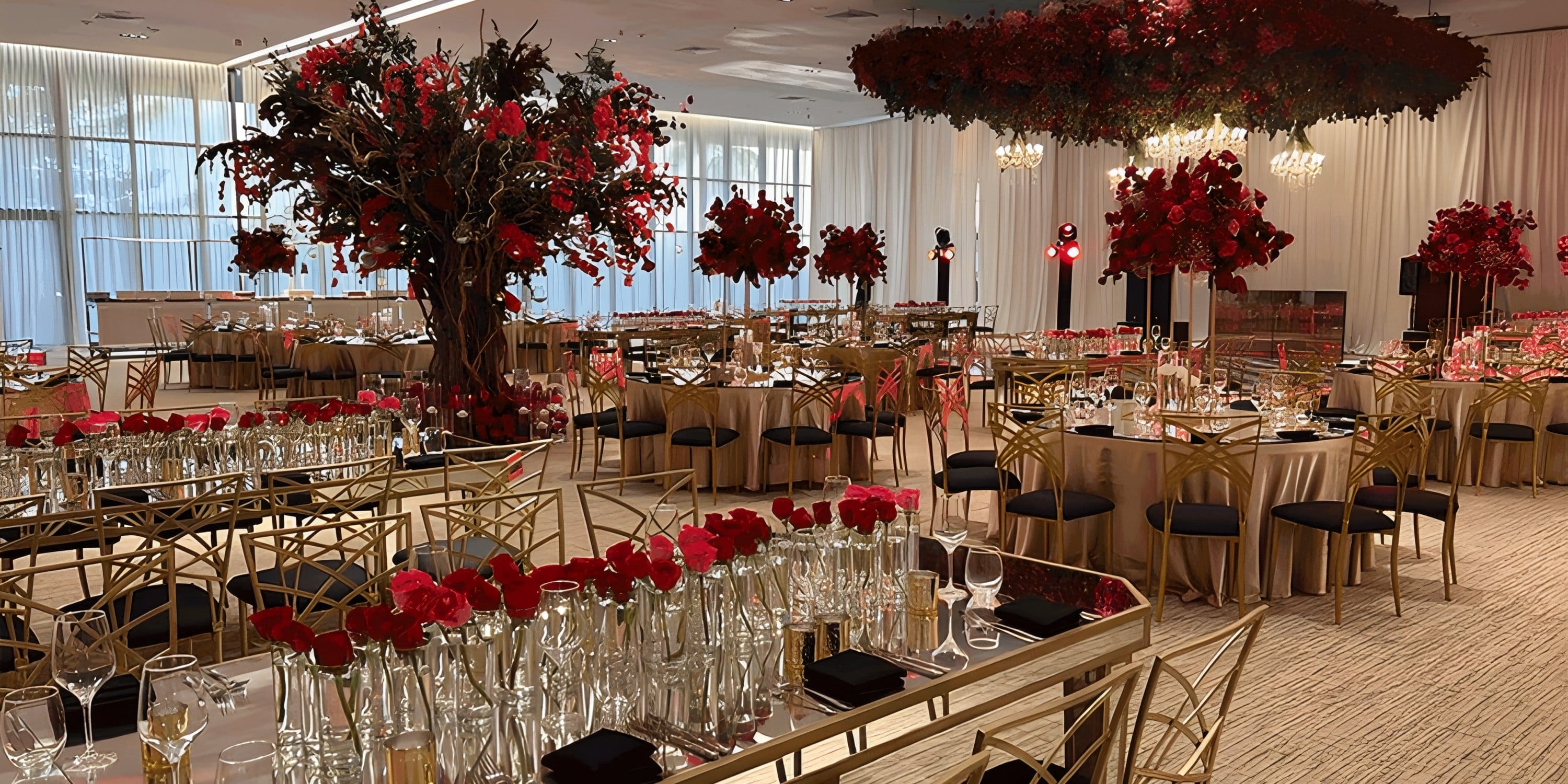 Banquet hall decorated with red flowers for a destination wedding at Dreams Playa Mujeres.