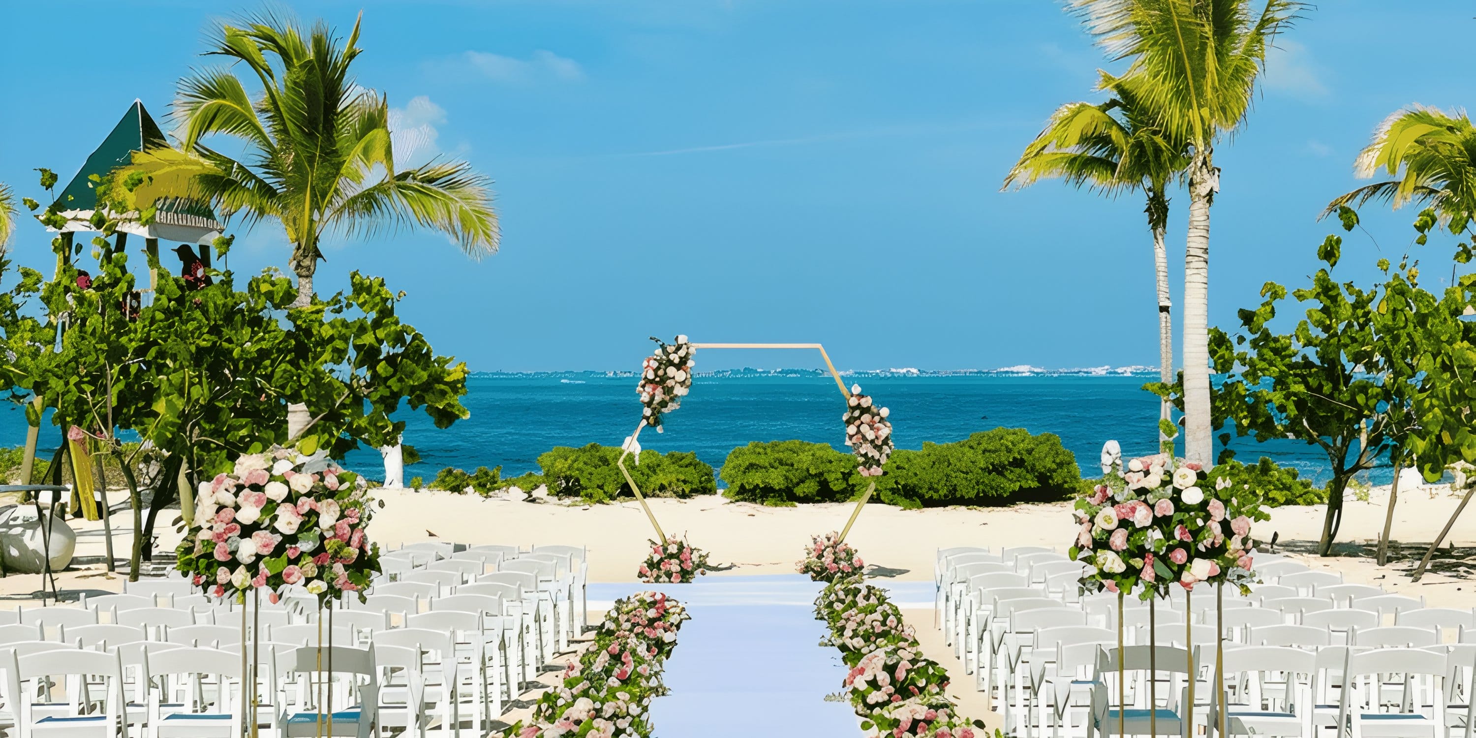 Destination wedding setup at Dreams Playa Mujeres with white chairs and a floral archway.
