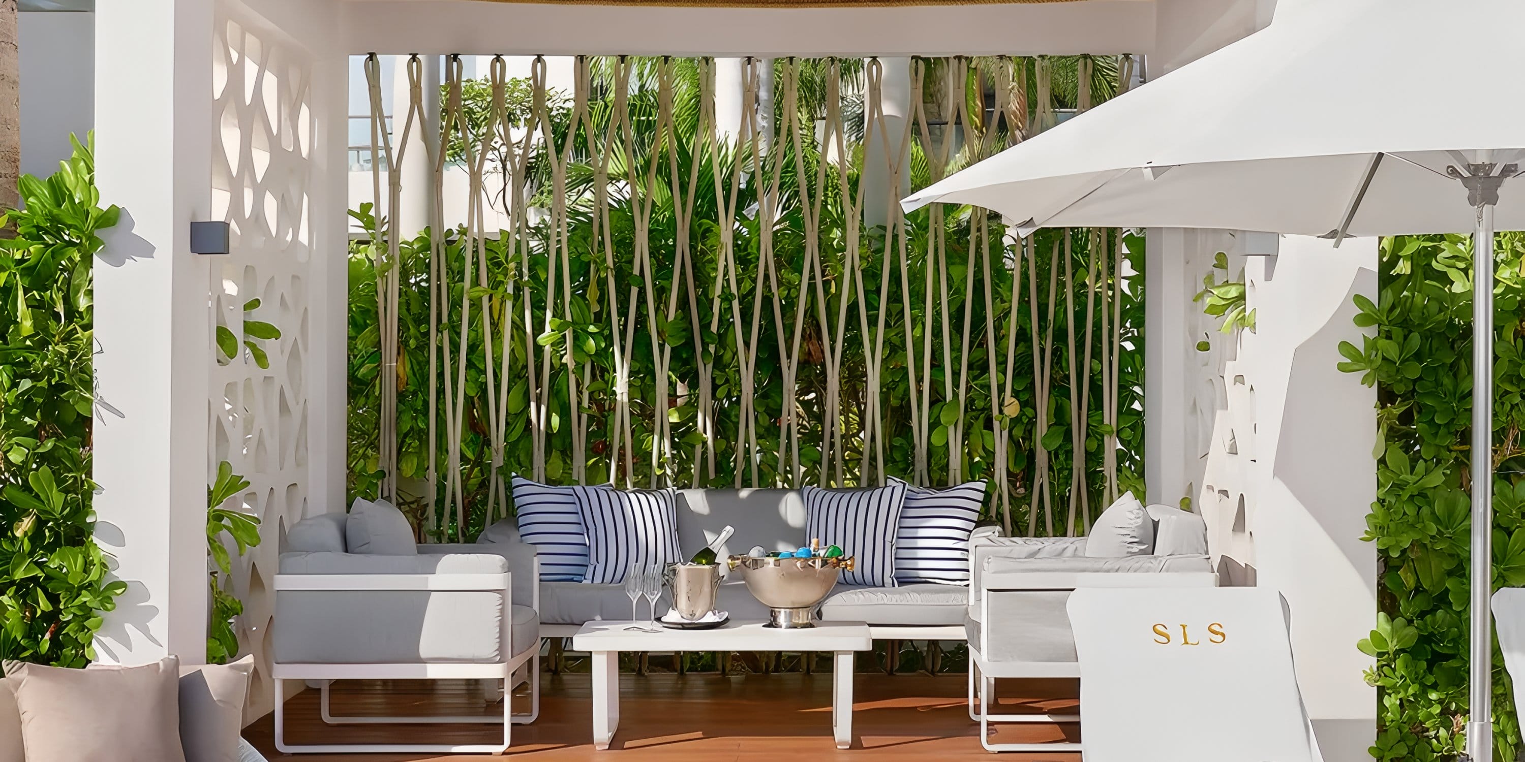Wedding seating area with sofa, chairs, and champagne bucket at Dreams Playa Mujeres.