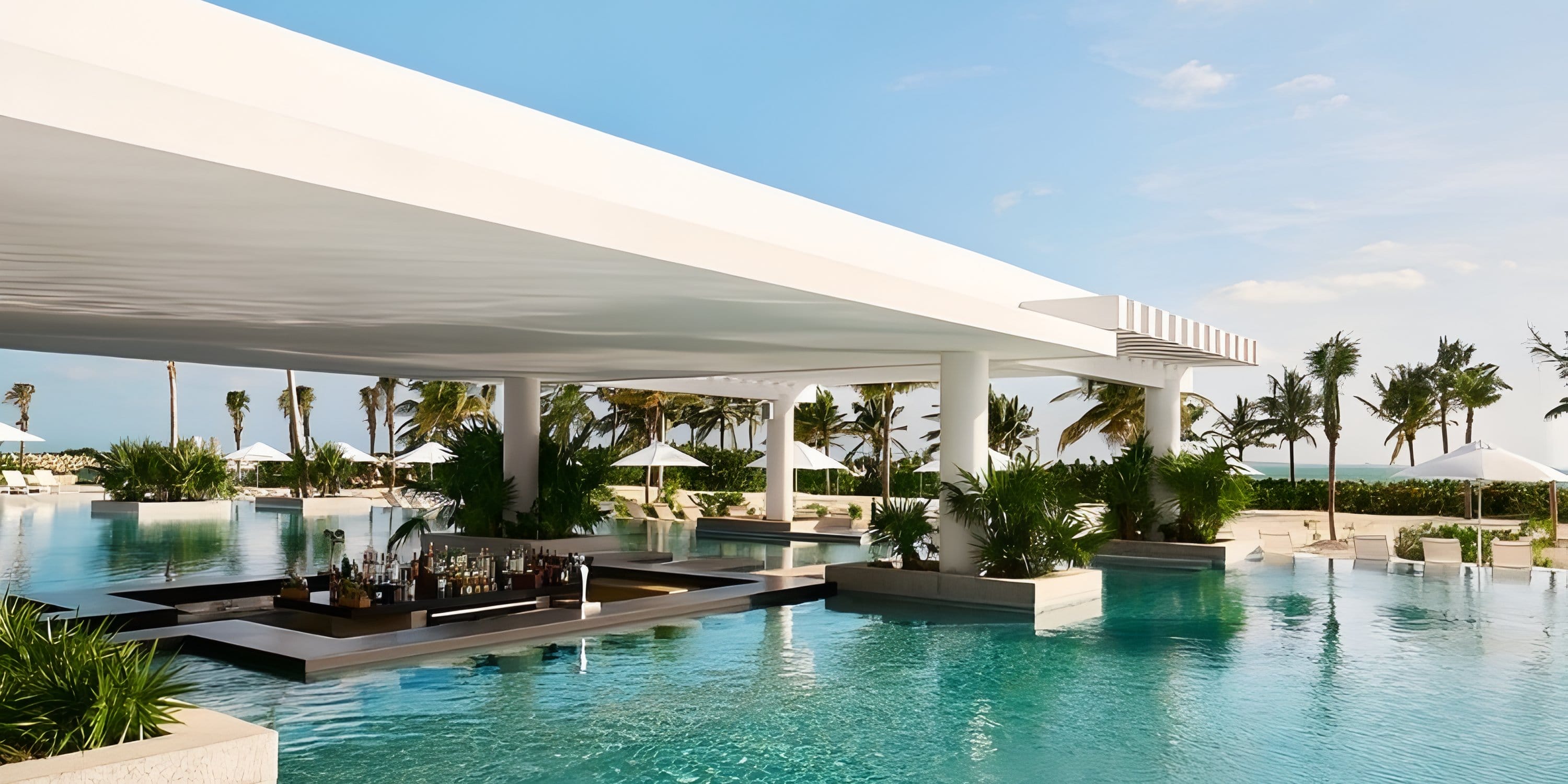 A swim-up bar at SLS Playa Mujeres, a perfect spot for a destination wedding, under a white canopy.