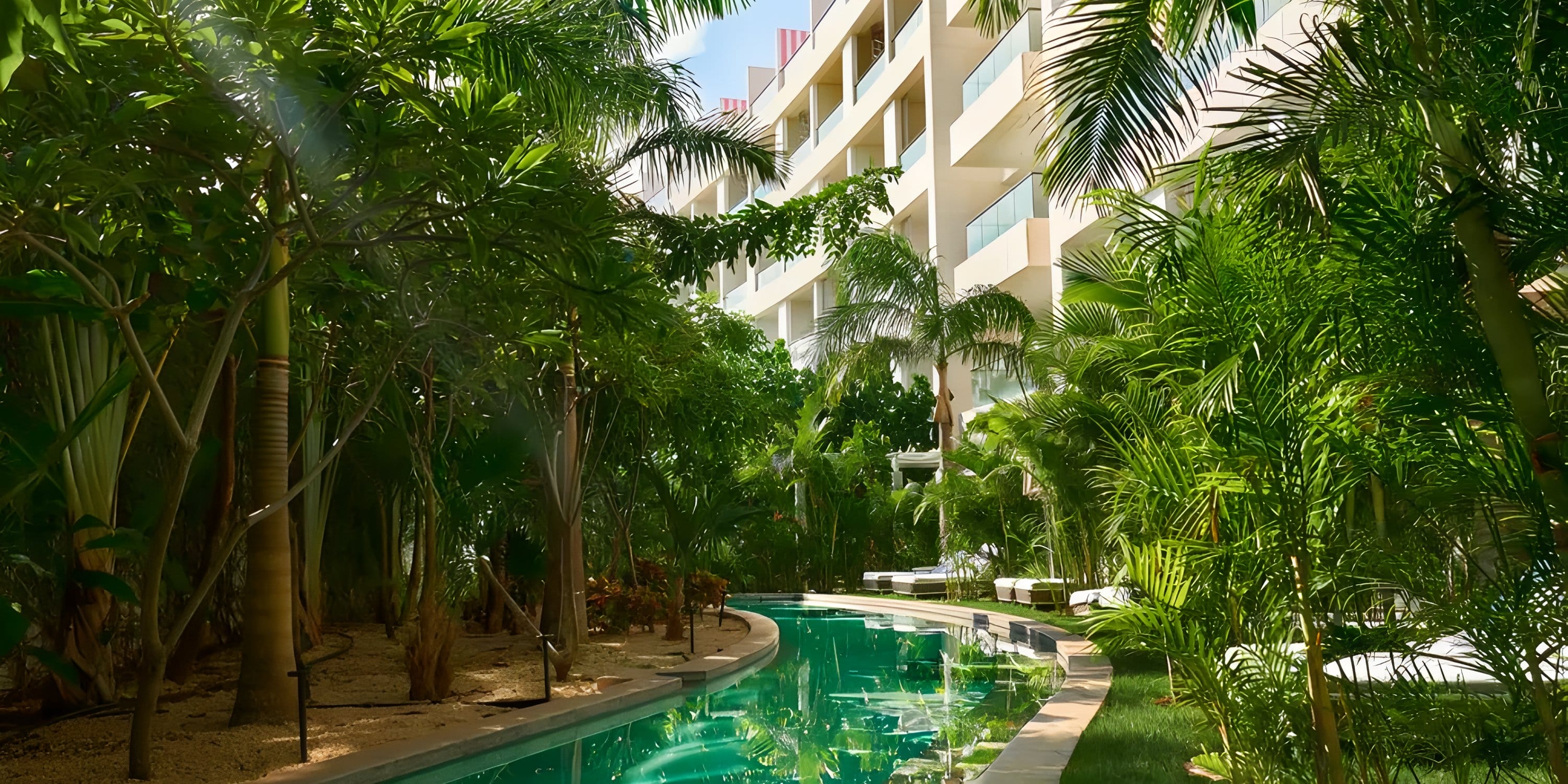 A winding pool at Dreams Playa Mujeres, a perfect setting for a destination wedding.