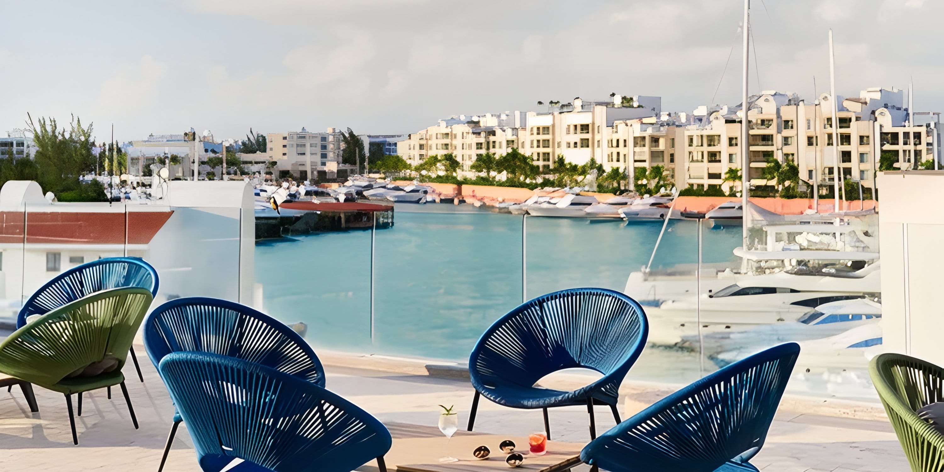 Patio seating at Dreams Playa Mujeres, an ideal destination wedding spot overlooking the marina.