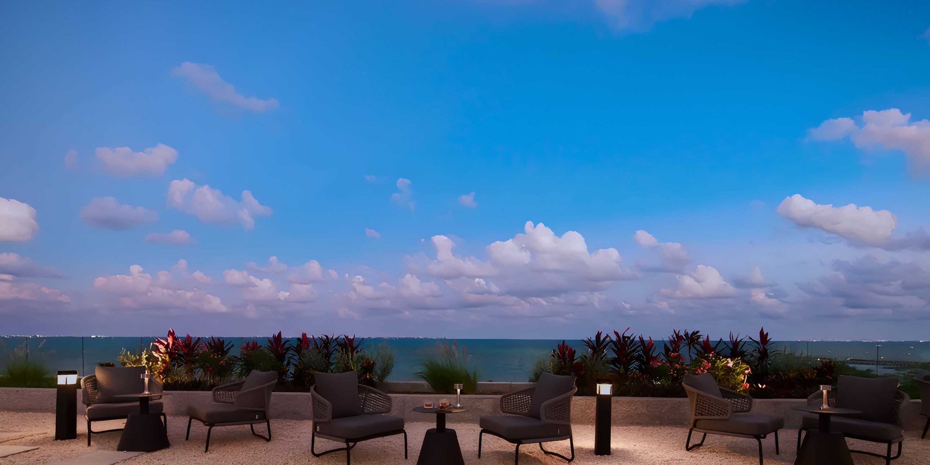 Outdoor patio seating at Dreams Playa Mujeres for a destination wedding overlooking the ocean.