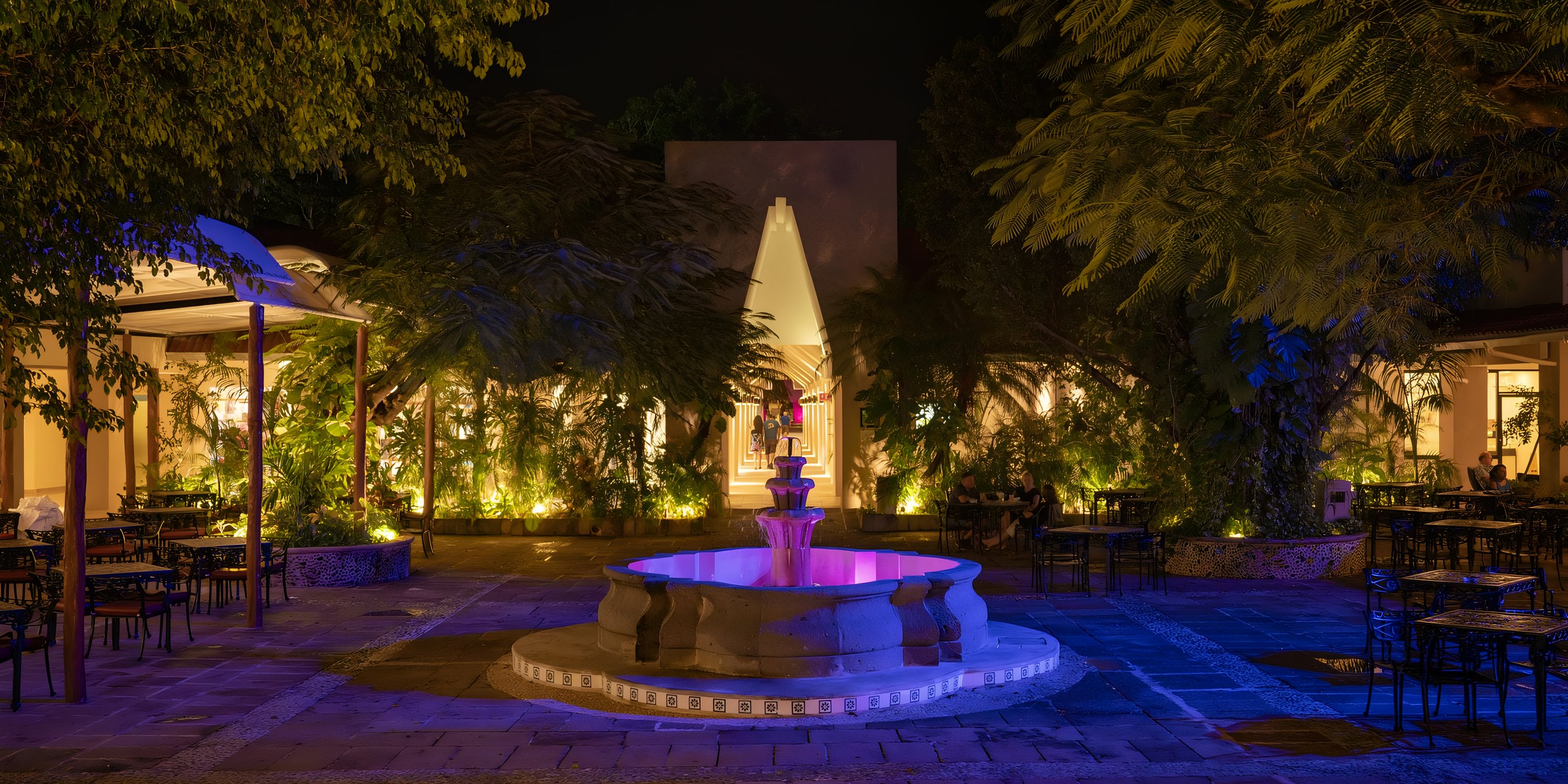 Illuminated courtyard with a fountain at night, perfect for a destination wedding at Viva Maya.
