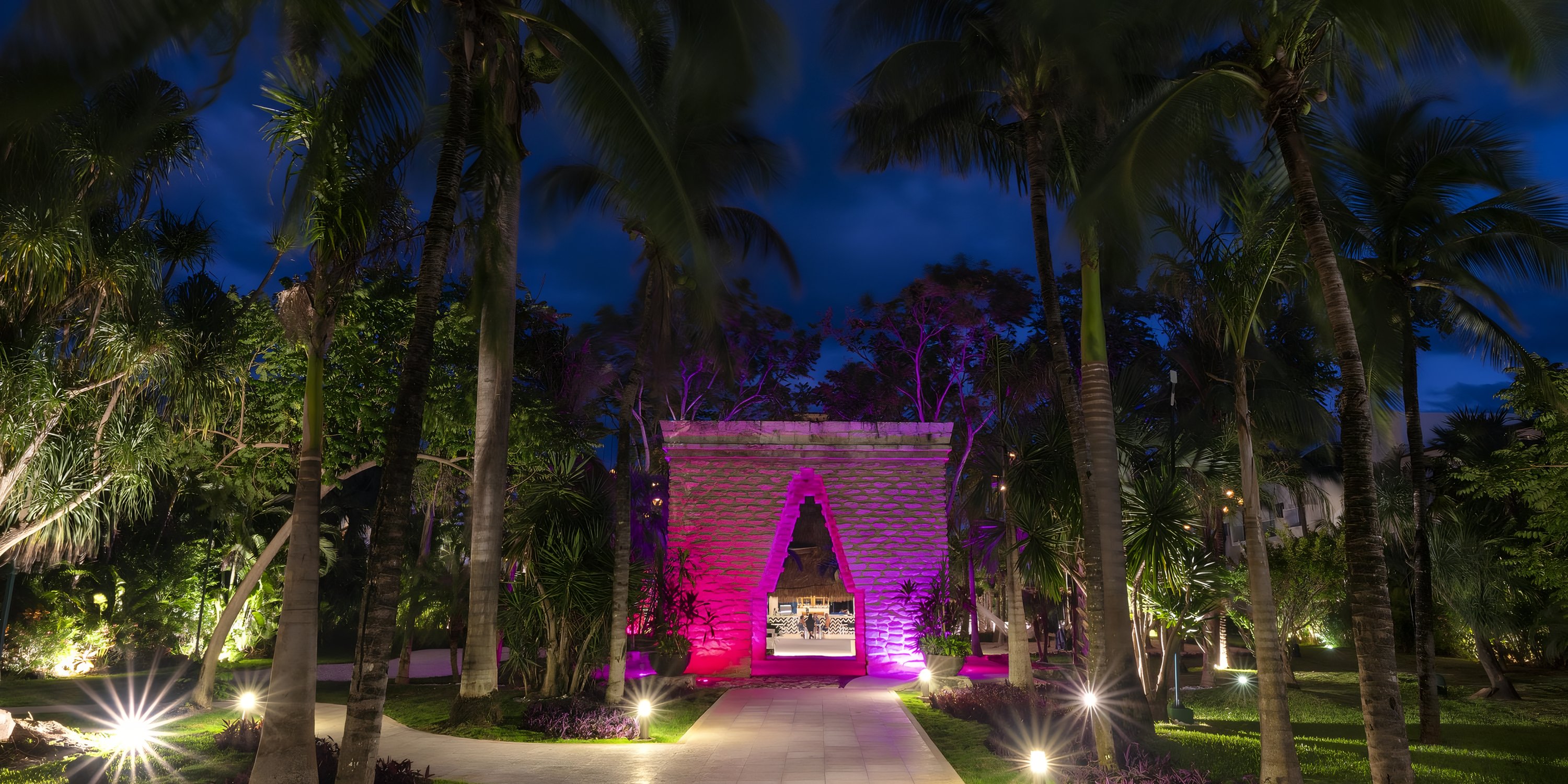 Stone archway at Viva Maya by Wyndham-All Inclusive Resort illuminated for a destination wedding.