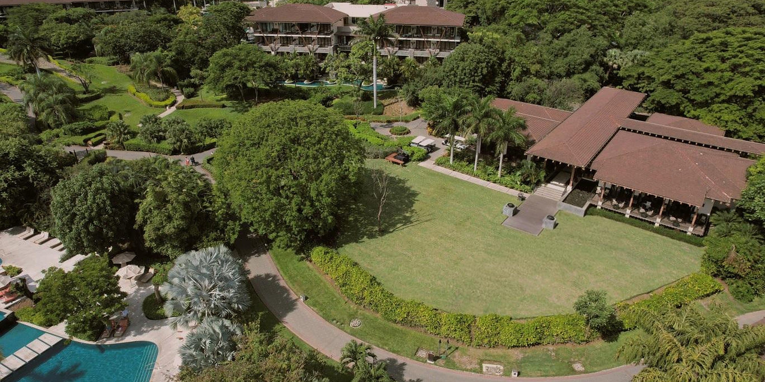 Aerial view of resort gardens and buildings, a popular destination wedding venue.