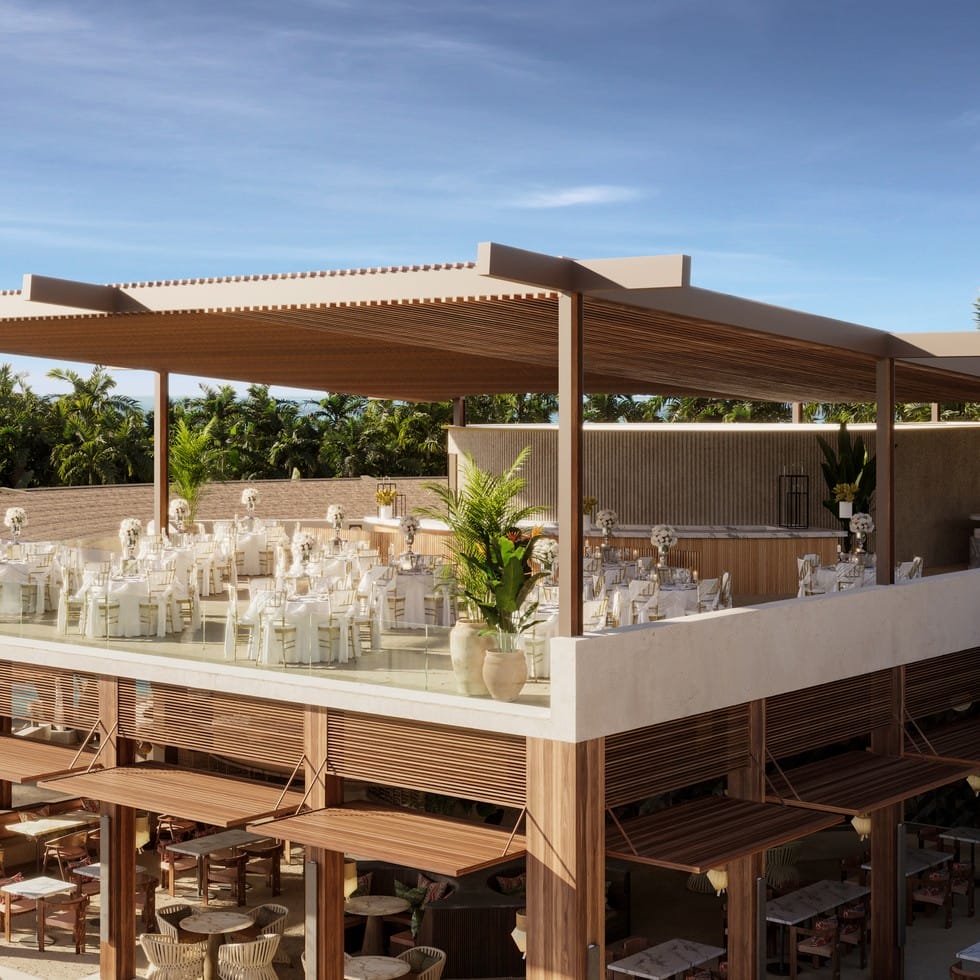 Destination wedding venue on a terrace overlooking a tropical landscape.