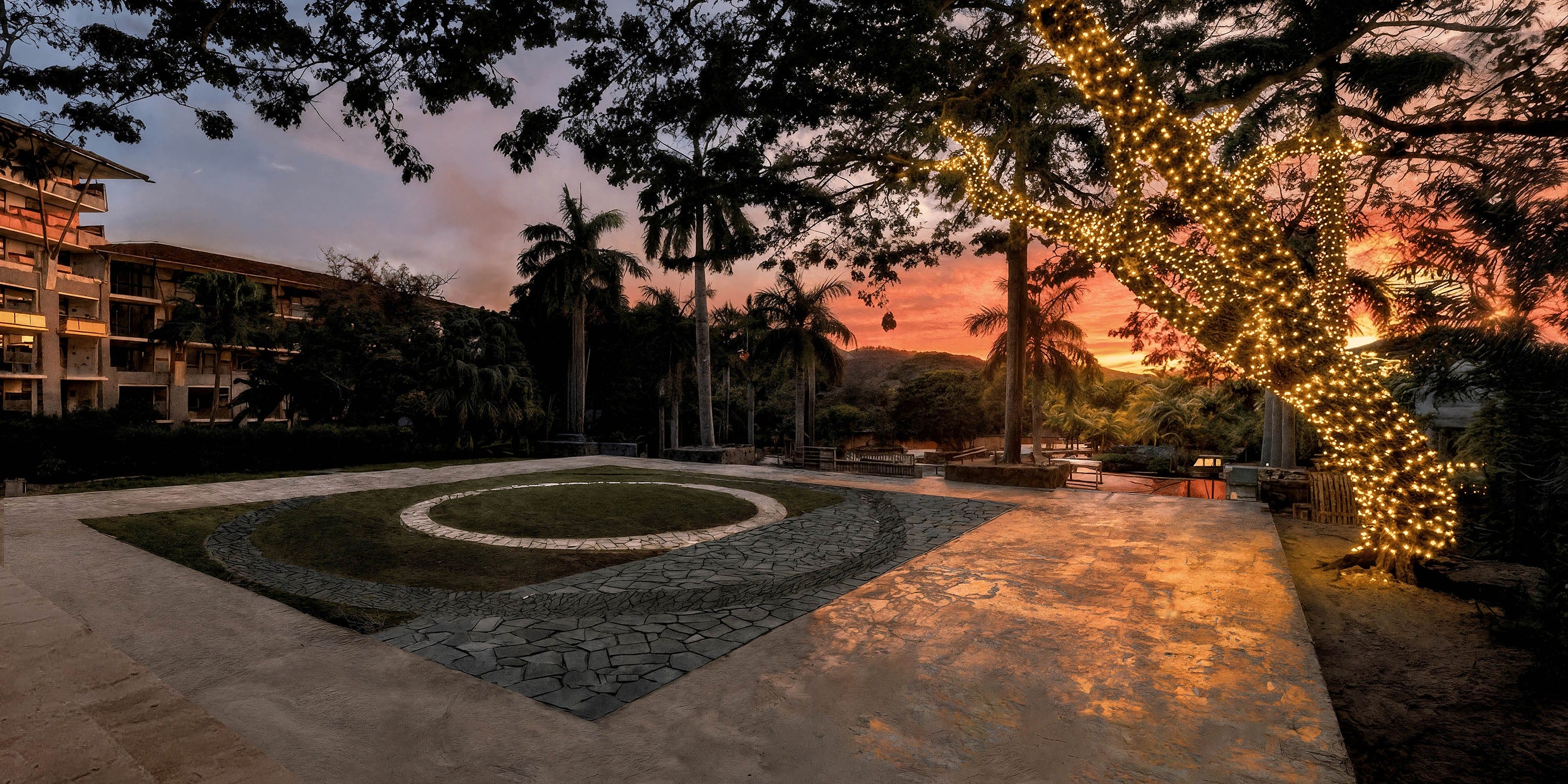 Fairy lights wrap the trees at this outdoor destination wedding at sunset.