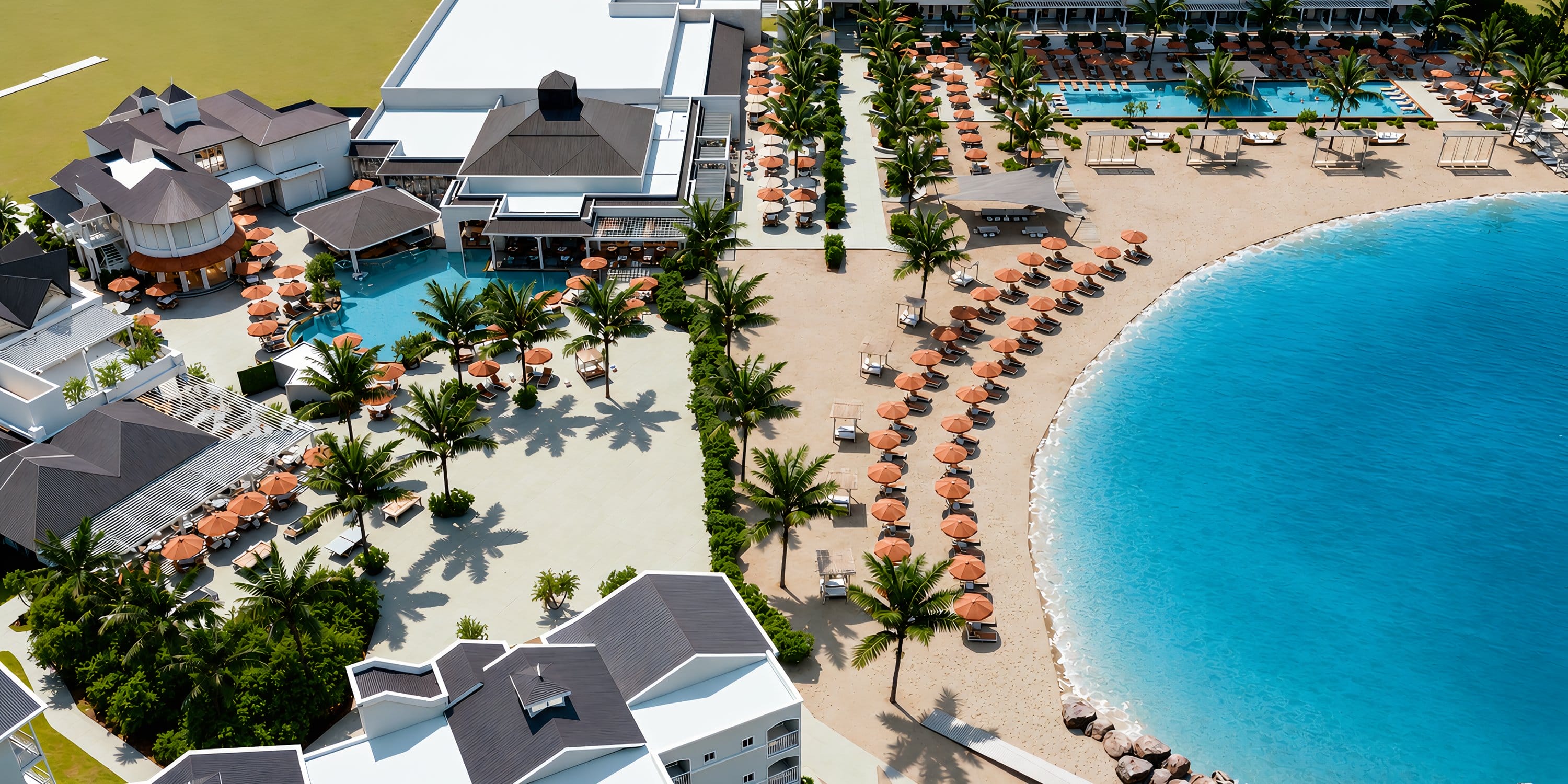 Aerial view of Royalton CHIC Antigua, a destination wedding resort with pools and beach umbrellas.