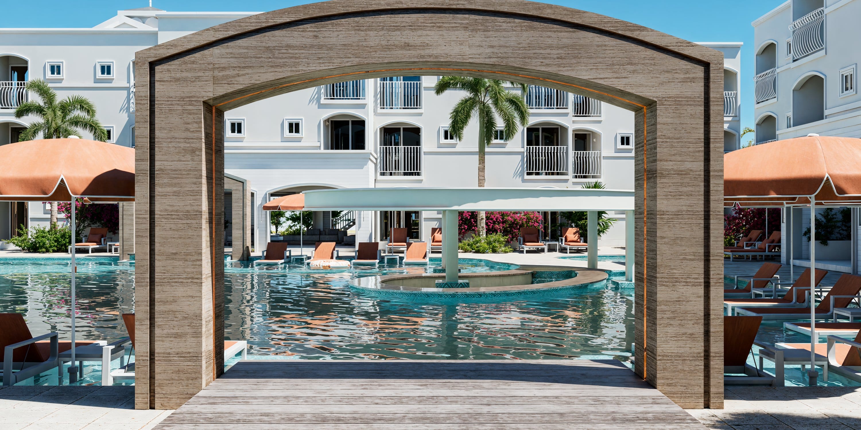 Arched wooden frame view of a Royalton CHIC Antigua pool, ideal for a destination wedding.
