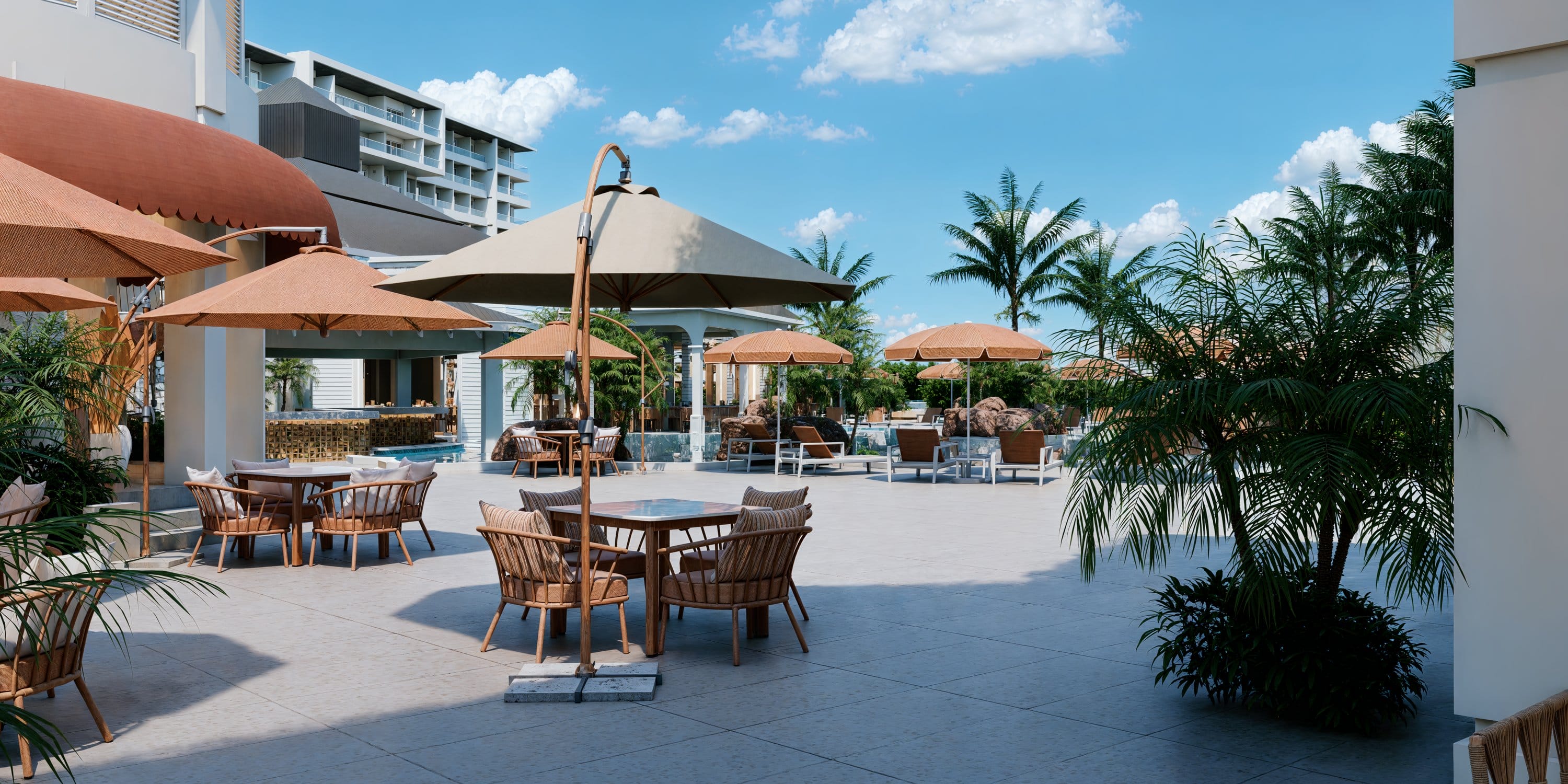 Outdoor terrace at Royalton CHIC Antigua, a destination wedding venue with tables and palm trees.