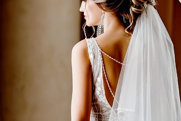 Bride in a lace wedding dress and veil at an SLS Playa Mujeres destination wedding.